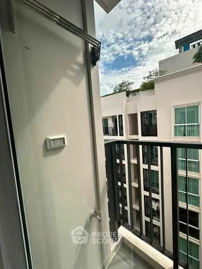 Modern apartment balcony with city view and sleek railing design