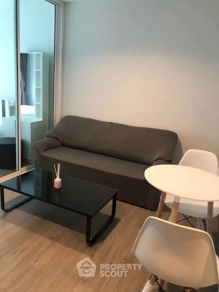 Modern living room with sleek furniture and wooden flooring, perfect for urban living.