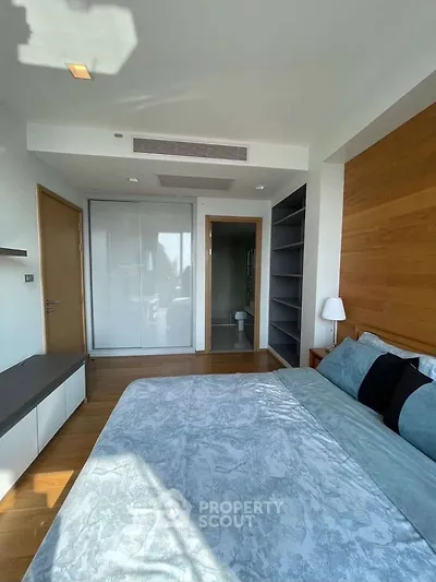 Modern bedroom with wooden accents and ample natural light