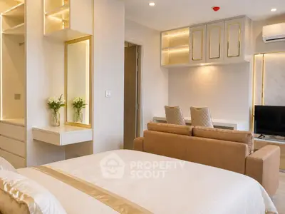 Luxurious modern bedroom with elegant decor and cozy seating area