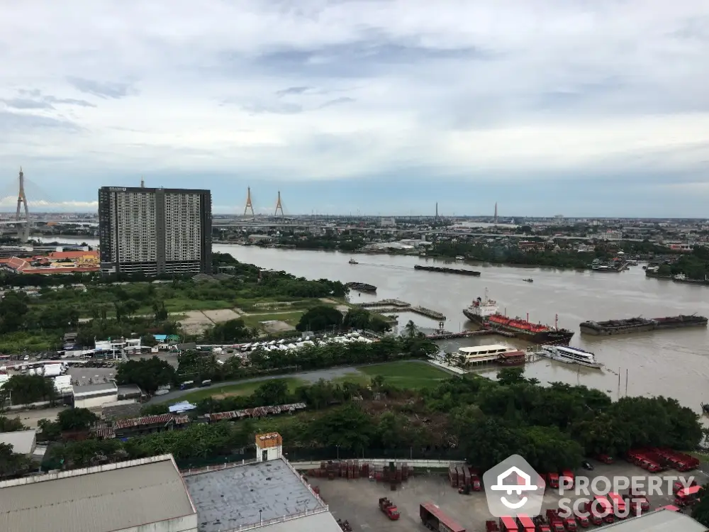 Stunning river view from high-rise building overlooking cityscape and lush greenery.