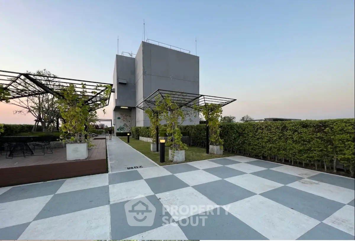 Modern rooftop garden with stylish seating and greenery