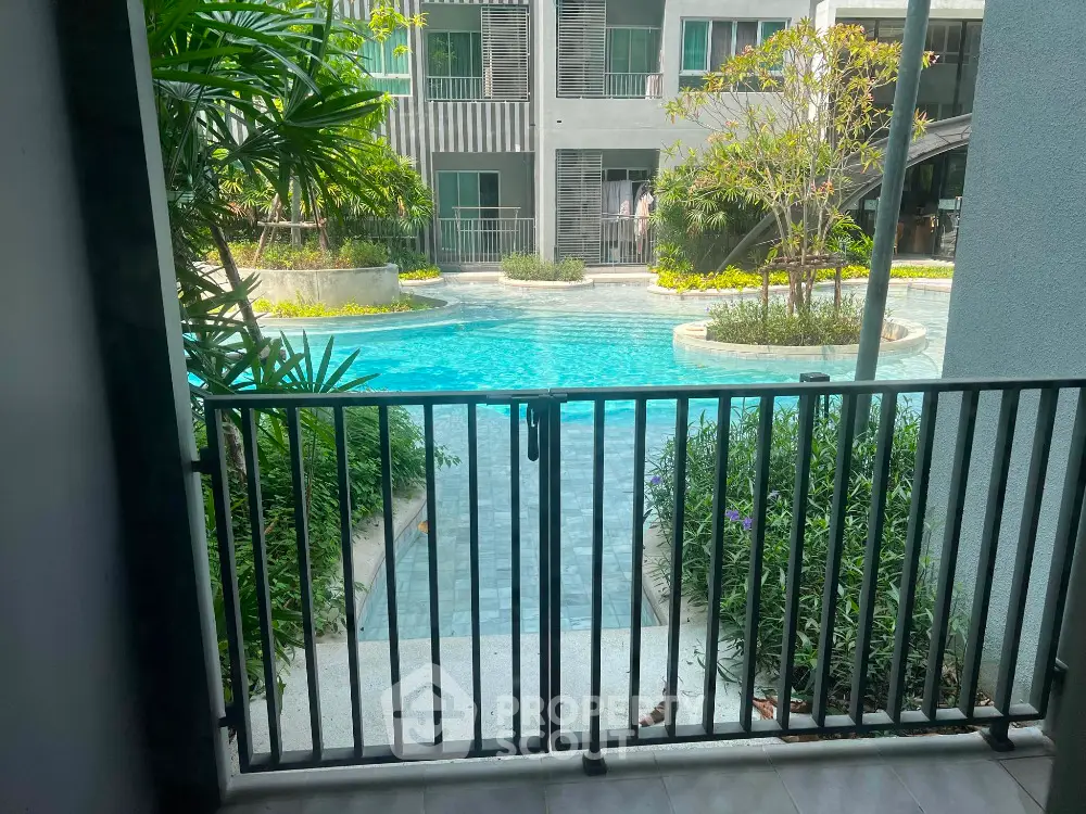Stunning pool view from a balcony in a modern residential complex.