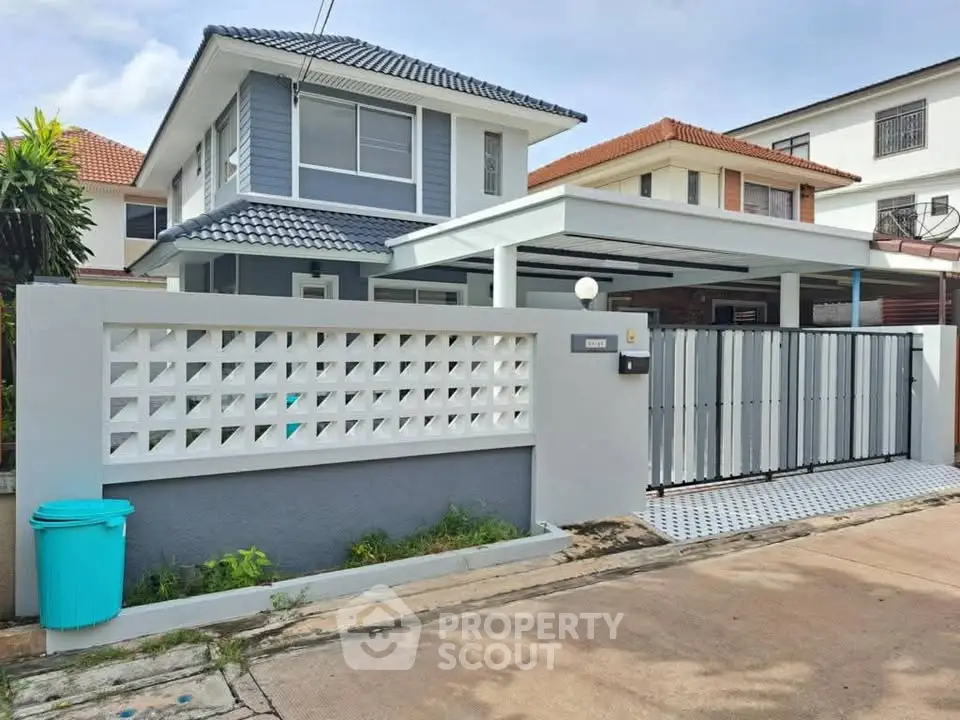 Charming two-story house with modern facade and spacious driveway in a serene neighborhood.
