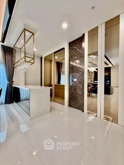 Luxurious modern living room with elegant marble accents and stylish lighting fixtures.