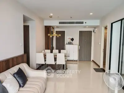 Modern living room with elegant dining area and stylish decor in a spacious apartment.