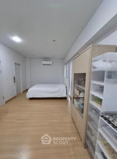 Spacious bedroom with modern furnishings and ample storage solutions.