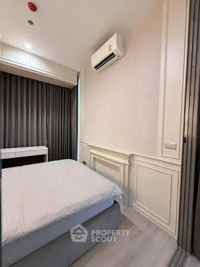 Cozy bedroom with modern air conditioning and elegant paneling, perfect for restful nights.