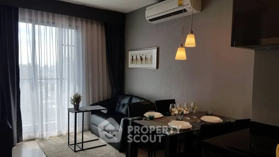 Modern living room with dining area and large window in stylish apartment