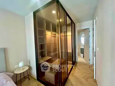 Modern bedroom with glass walk-in closet and elegant parquet flooring