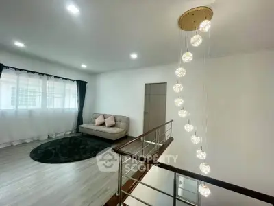 Modern living room with elegant lighting and cozy seating area, perfect for relaxation.