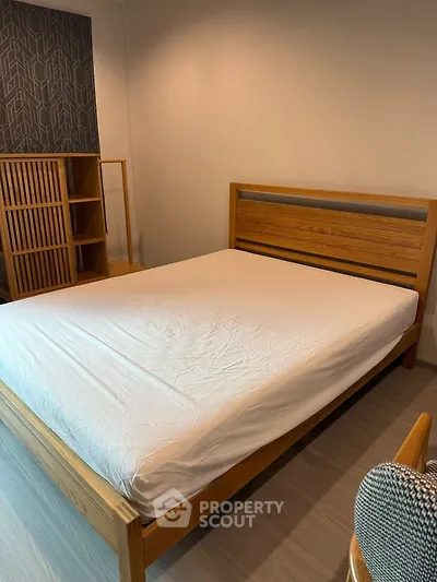 Spacious bedroom with modern wooden bed and stylish decor