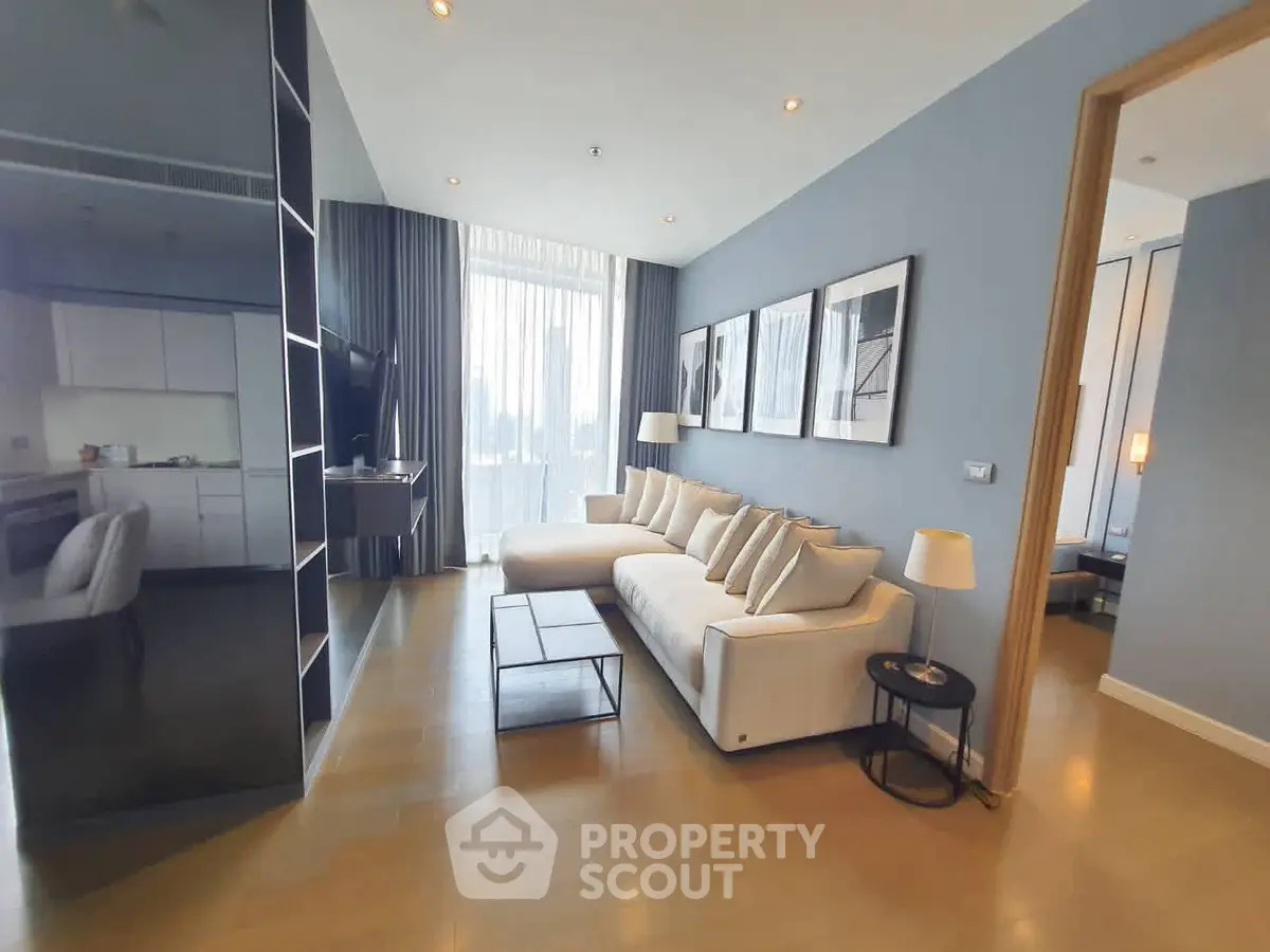 Spacious modern living room with elegant decor and large windows offering natural light.