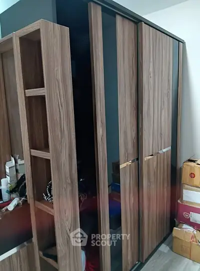 Modern wooden wardrobe with sliding doors in a stylish bedroom setting.