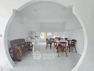 Modern minimalist interior with unique circular doorway and stylish wooden furniture