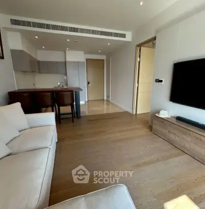 Spacious modern living room with open kitchen and elegant wooden flooring