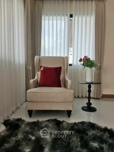 Elegant living room corner with plush armchair and chic decor