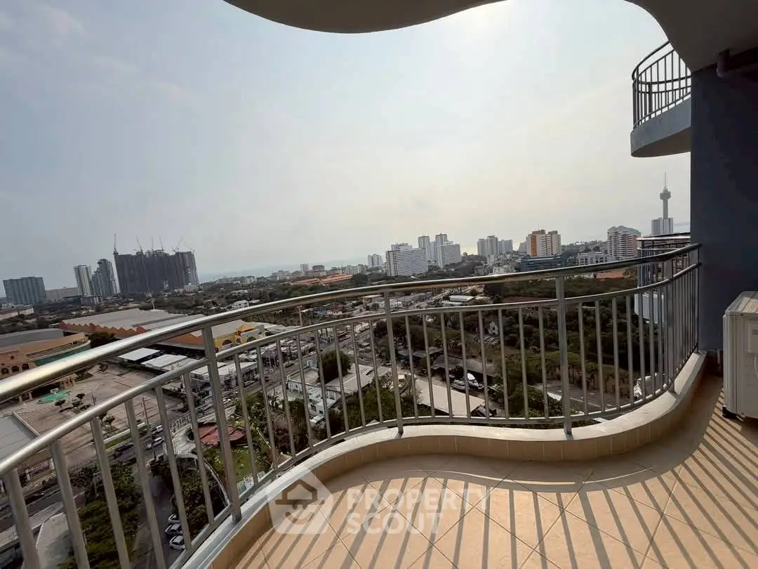Stunning cityscape view from a spacious balcony in a high-rise apartment.