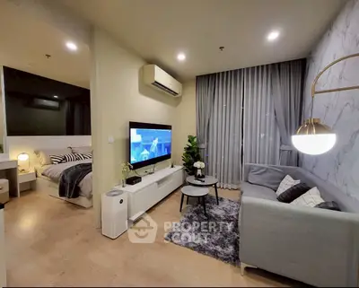 Modern living room with stylish decor and cozy ambiance, featuring a sleek TV setup and elegant lighting.