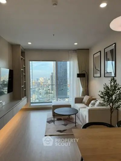 Modern living room with large window offering stunning city view, stylish decor, and cozy seating area.