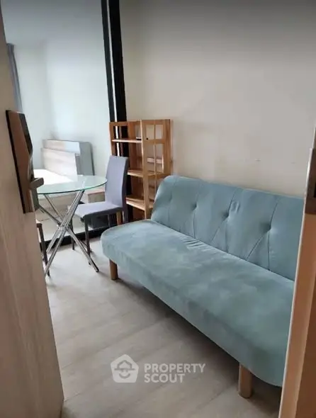 Cozy living area with modern sofa and dining set in compact apartment