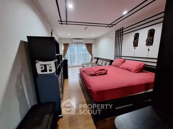 Spacious bedroom with modern decor and balcony access