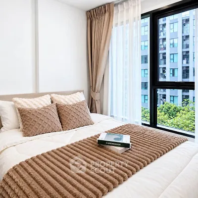 Cozy bedroom with elegant decor and city view, featuring plush bedding and large windows.