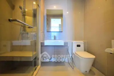 Modern bathroom with sleek fixtures and glass shower enclosure