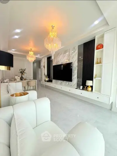 Luxurious modern living room with elegant chandeliers and marble accents