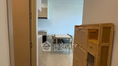 Modern apartment interior with dining area and wooden furniture, showcasing minimalist design.