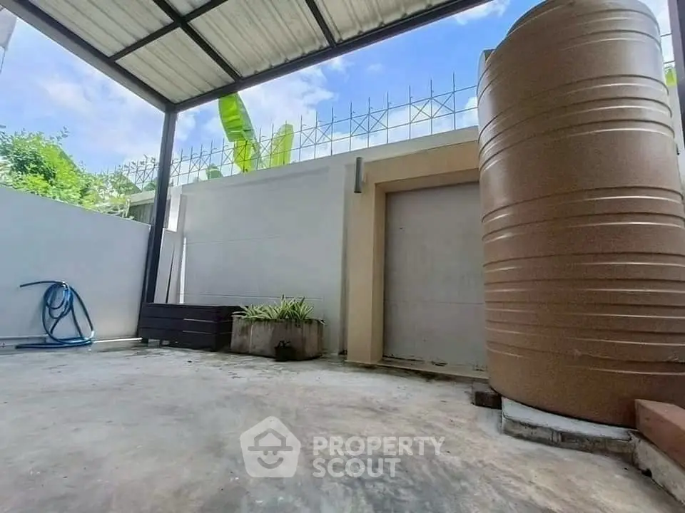 Spacious outdoor area with water tank and garden potential