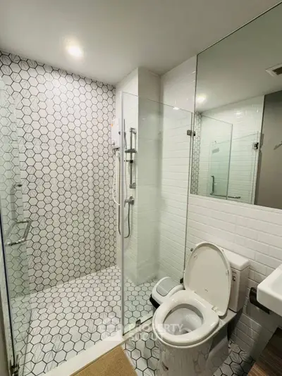 Modern bathroom with glass shower and stylish tile design