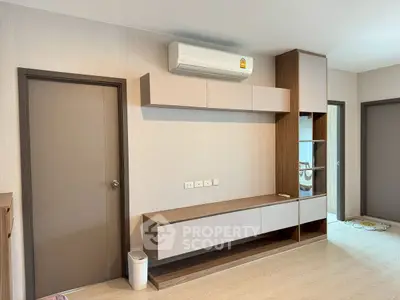 Modern living room with sleek storage and air conditioning unit