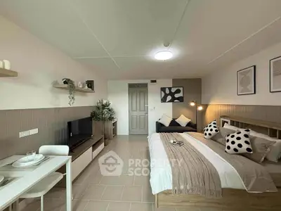 Modern studio apartment with cozy bedroom and living area, featuring stylish decor and natural lighting.