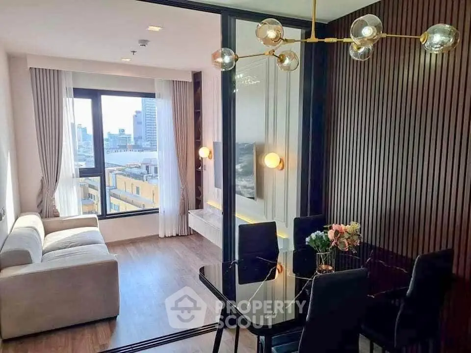 Modern living room with city view, elegant lighting, and stylish dining area in a high-rise apartment.