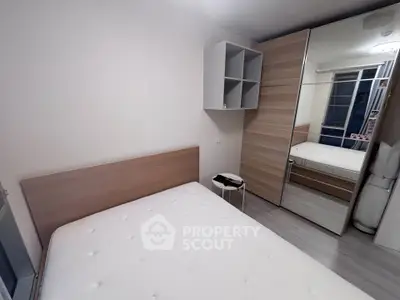 Modern minimalist bedroom with wooden accents and mirrored wardrobe