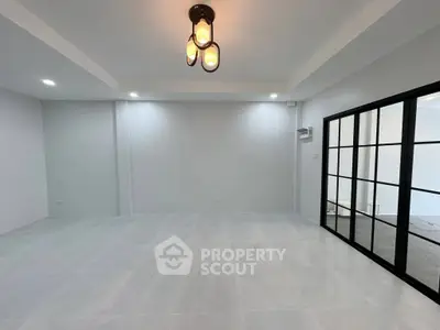 Spacious modern living room with elegant lighting and glass doors