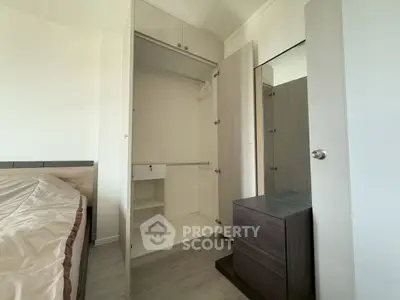 Spacious bedroom with open wardrobe and modern furniture