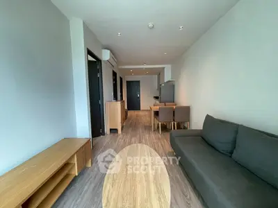 Modern living room with sleek furniture and open dining area