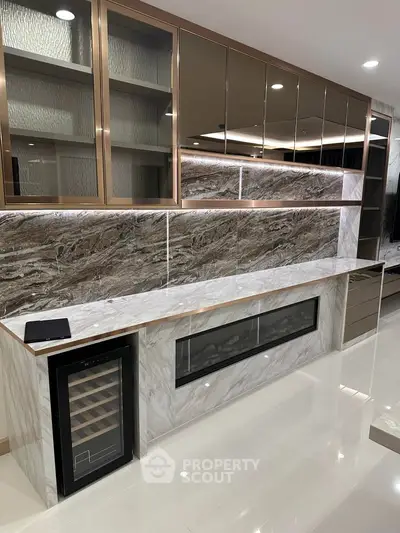 Luxurious modern living room with marble accents and built-in wine cooler