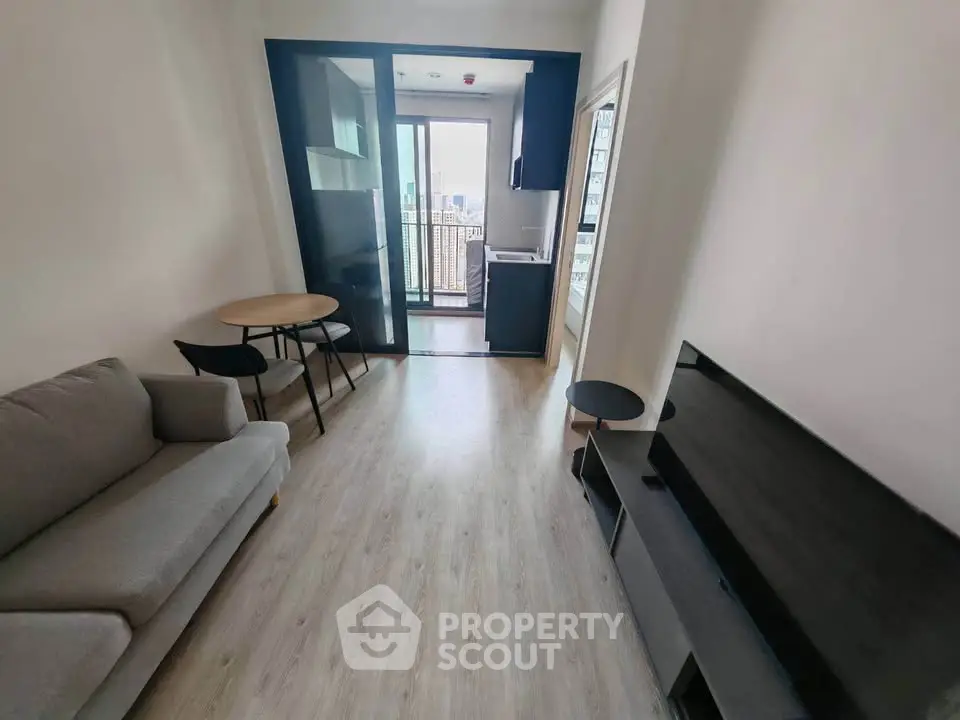 Modern living room with sleek furniture and balcony view