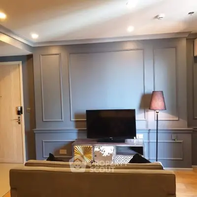 Stylish living room with modern decor and TV setup, perfect for relaxation.