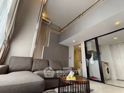 Modern loft-style living room with mezzanine and washing machine, featuring sleek design and cozy ambiance.