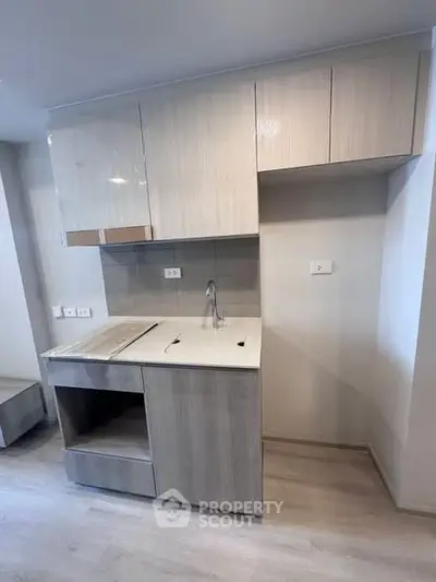 Modern kitchen with sleek cabinetry and minimalist design in a contemporary apartment.