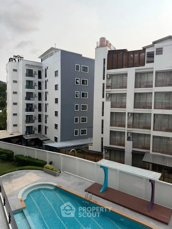 Modern apartment buildings with a swimming pool view, ideal for urban living.