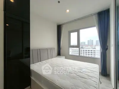 Modern bedroom with large window offering city view in high-rise apartment
