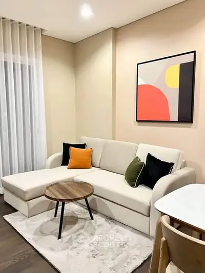 Modern living room with stylish sofa and abstract art on wall