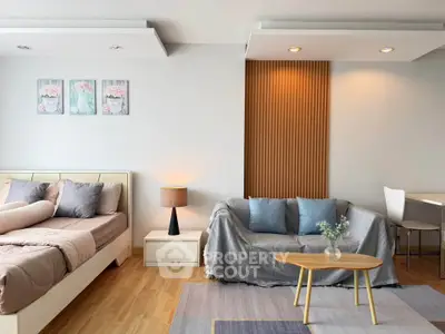 Modern living room with cozy sofa, stylish decor, and elegant lighting in a chic apartment.