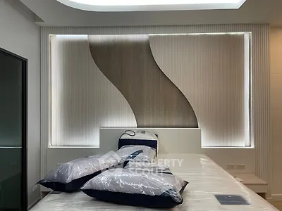 Modern bedroom with stylish wall design and cozy bedding