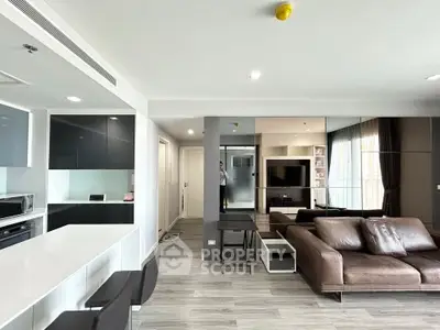 Modern open-plan living room with sleek kitchen and stylish furniture